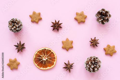 Winter or Christmas flat lay with star anise gingerbread cookies on pink