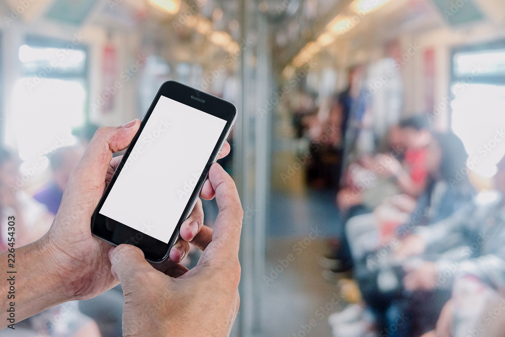 Man hands using smart phone with blurred electric train background. Blank screen for graphics display montage. Man hands using smart phone with blurred electric train background. Blank screen for graphics display montage.