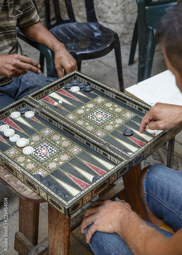 Men playing backgammon at the old city, Acre (Akko), Israel.