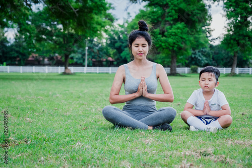 Mother and child meditation in park