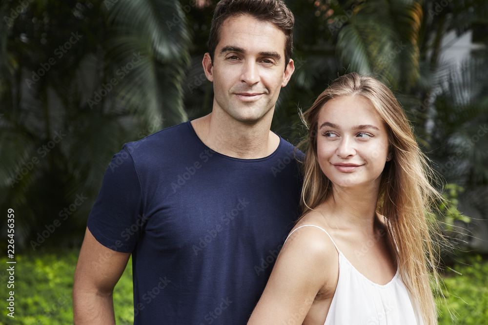 Good looking couple smiling to camera and away Good looking couple smiling to camera and away