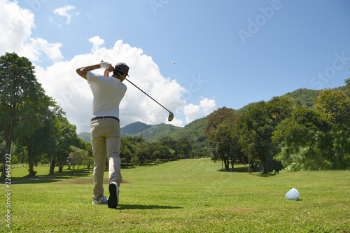  Young Asian man playing golf on a beautiful natural golf course