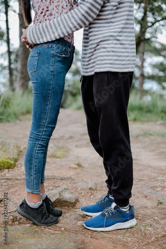 A young loving couple hugging and kissing on the forrest.