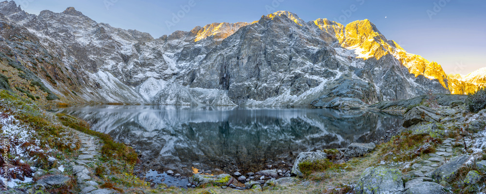Tatra National Park, a lake in the mountains at the dawn of the sun. Poland - obrazy, fototapety, plakaty 