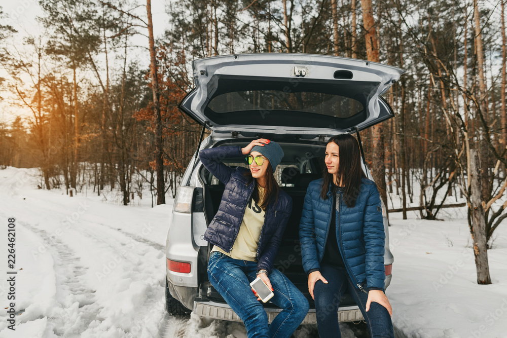 Girlfriends winter wear snowy day winter forest car
