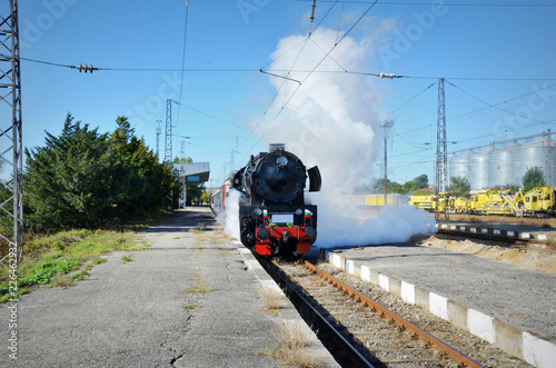 Retro steam train departs from the railway station