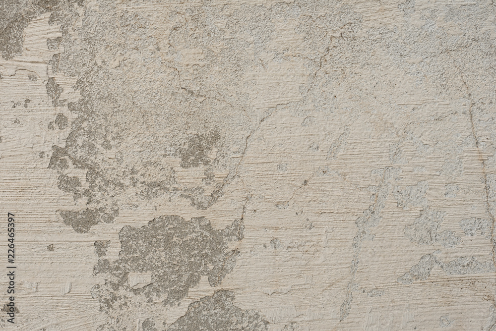 Fototapeta premium Wall fragment with scratches and cracks. It can be used as a background