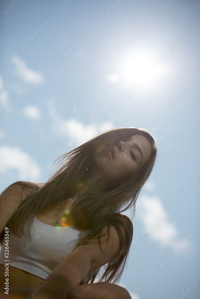 Portrait of a young beautiful woman on the sky background. Portrait of a young beautiful woman on the sky background.