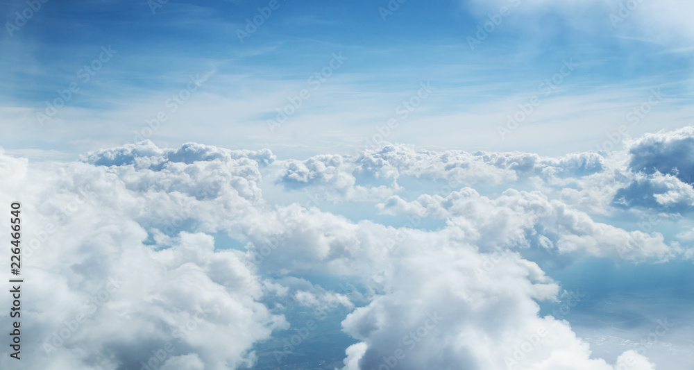 Blue sky and clouds background with lots of copy space.