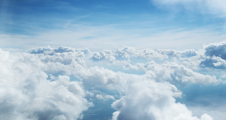 Blue sky and clouds background with lots of copy space.