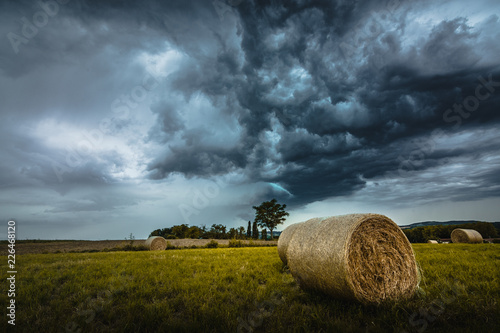 Canvas Print Orage et meules de foin