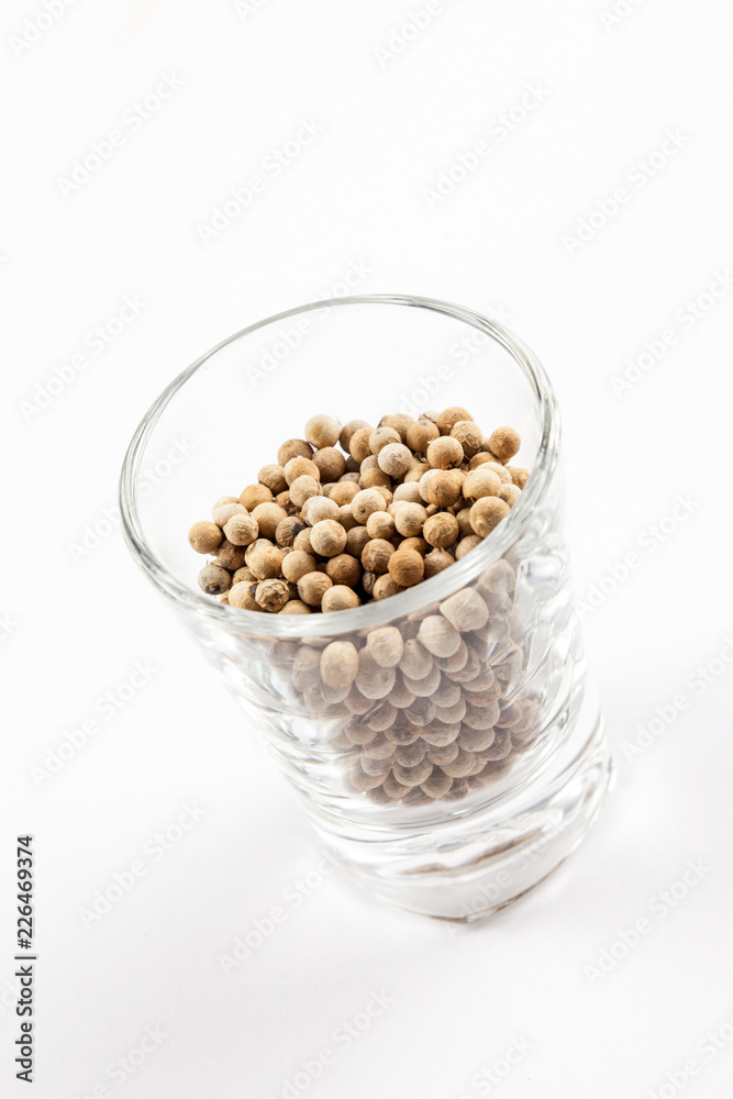 White pepper seeds in a glass Isolated On White Background, ingredient White pepper seeds in a glass Isolated On White Background, ingredient
