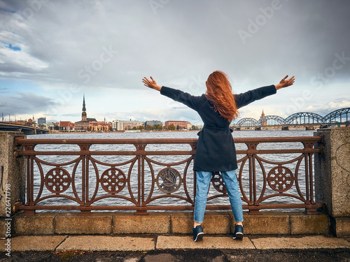 The girl on the bridge welcomes the city. © alexeyvronsky