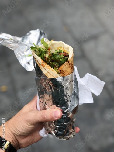 Chicken curry wrap with salad wrapped in foil from a street food market