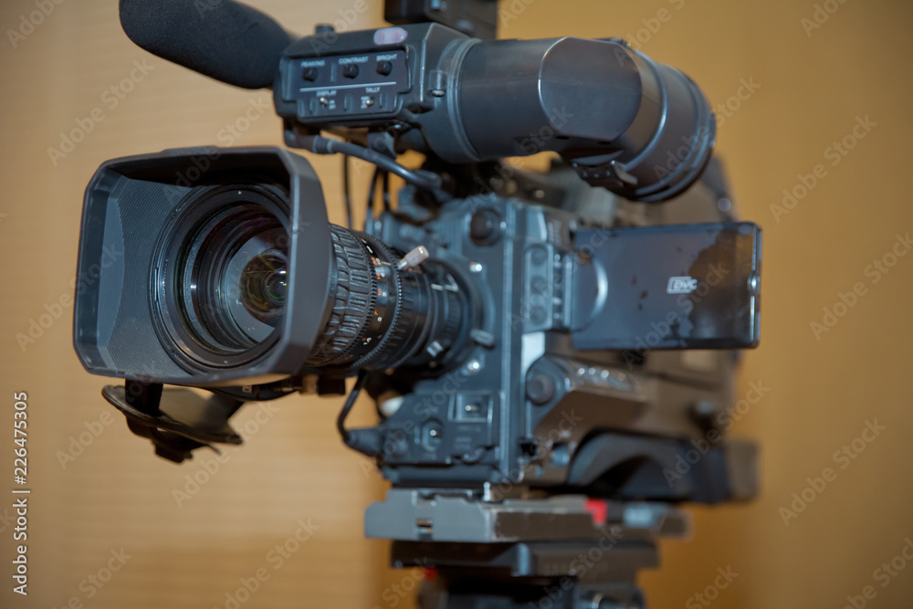 Professional video camera set on a tripod with excellent clipping path . Professional production video camera. video camera in business conference room recording participants