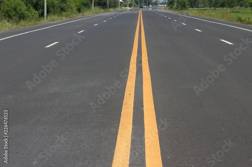 Asphalt road with yellow line