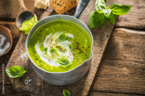 Green pea creamy soup in pot
