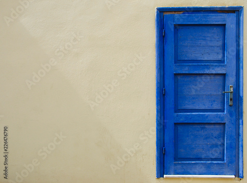 blue seperated door at a wall in Sissi on Crete in Greece photo