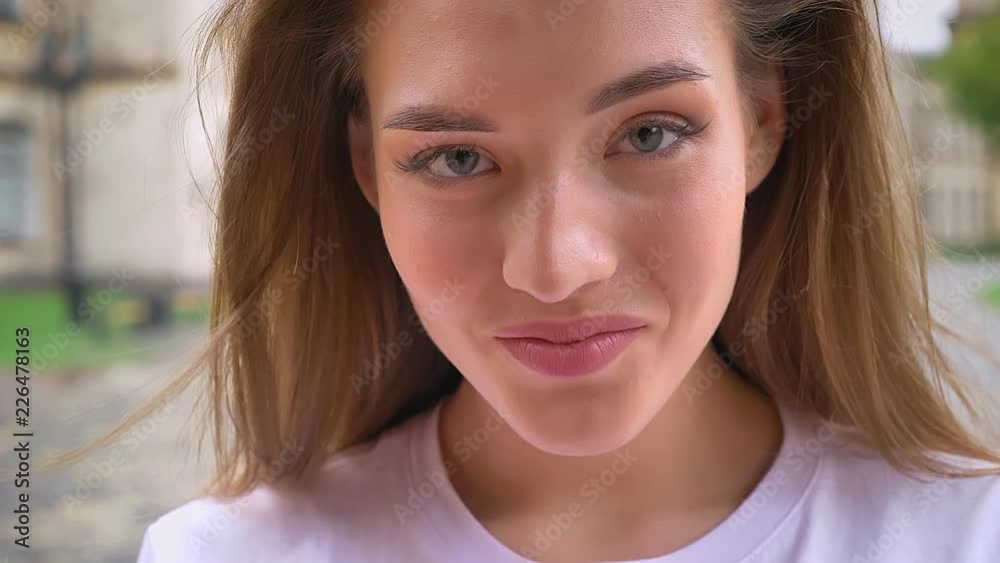 cute smiling caucasian woman, smiling face and natural look at camera outdoor cute smiling caucasian woman, smiling face and natural look at camera outdoor