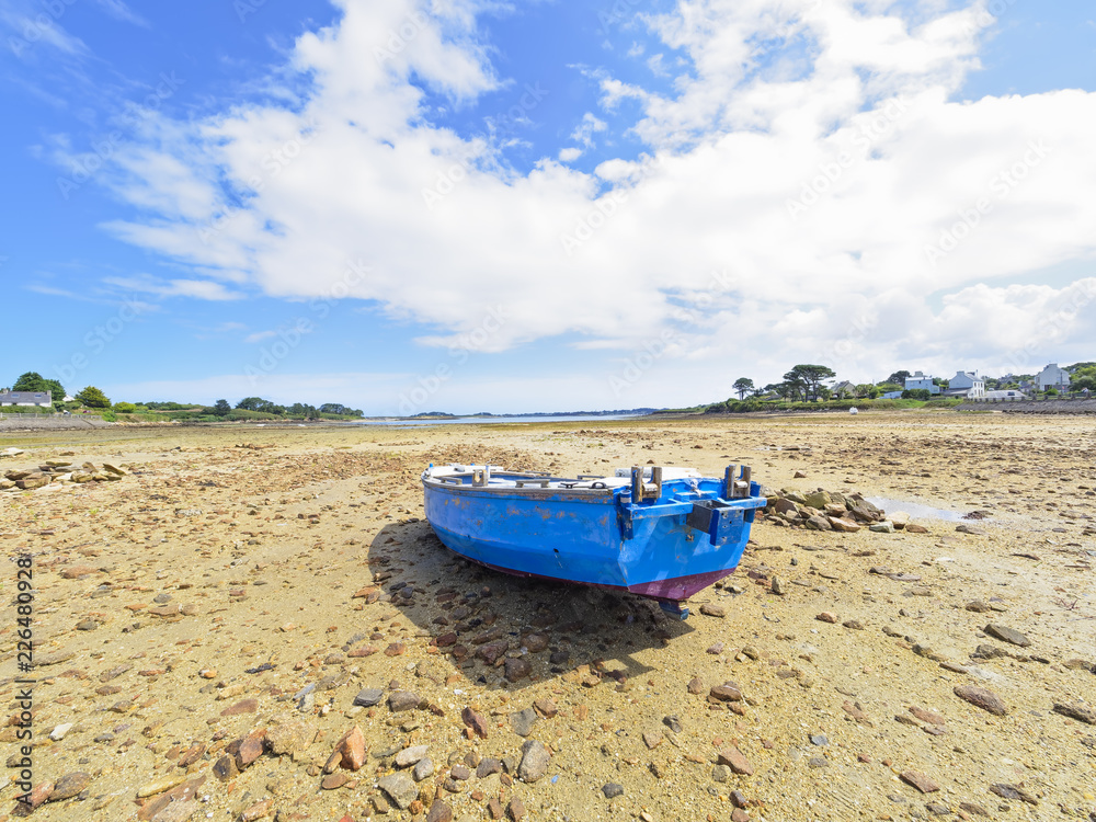 Small fishing boat beached in Kermengi harbour at low tide. Small fishing boat beached in Kermengi harbour at low tide.