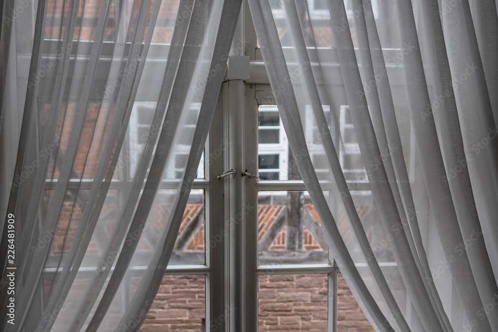 The window with curtain of an old farmhouse inside The window with curtain of an old farmhouse inside