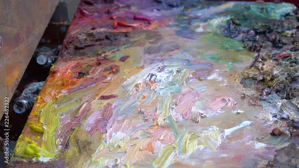 The Artist's Oil Palette. Mixing oil paint for painting slow motion The Artist's Oil Palette. Mixing oil paint for painting slow motion