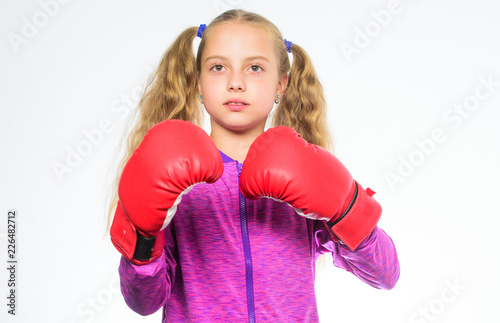 She ready to defend herself. Sport upbringing for girls. Feminist movement. Self defence concept. Girl boxer knows how defend herself. Girl child strong with boxing gloves posing on white background