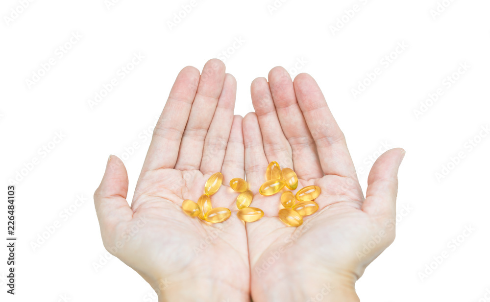 Hand holding Fish oil capsules on isolated white. Hand holding Fish oil capsules on isolated white.