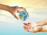 Hand is holding earth for give to empty 2 hands with blur sunrise sky background on conservation and save earth concept,Elements of this image finished by NASA