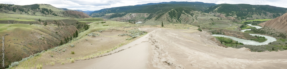 Panoramic view of the beautiful BC grasslands, the sand dune and Chilcotin River at Farwell Canyon - in spring/early summer.