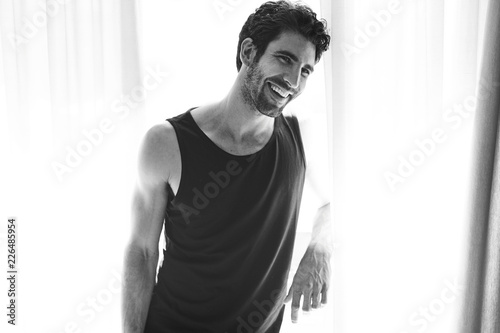Tableau sur toile Laughing guy in vest, looking away
