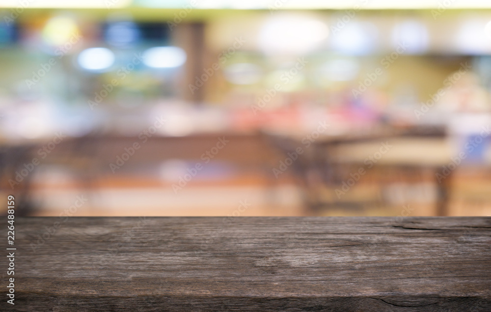 Empty dark wooden table in front of abstract blurred bokeh background of restaurant . can be used for display or montage your products.Mock up for space. Empty dark wooden table in front of abstract blurred bokeh background of restaurant . can be used for display or montage your products.Mock up for space.