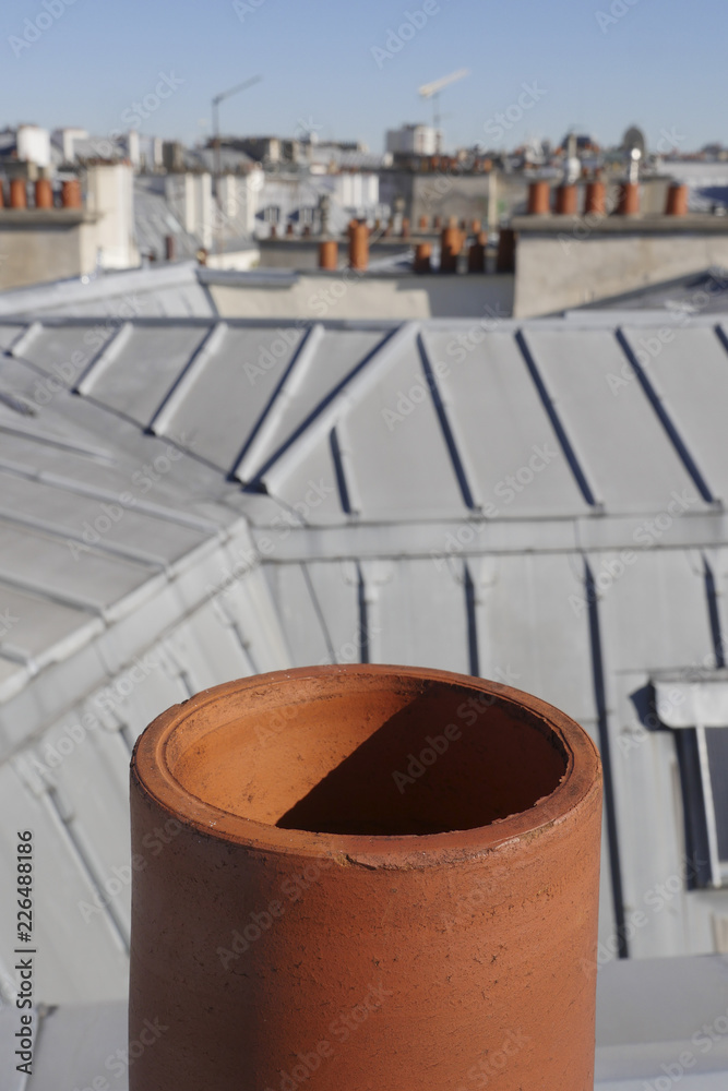 The roofs of Paris and its chimneys under a clouds sky The roofs of Paris and its chimneys under a clouds sky