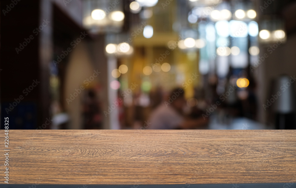 Empty dark wooden table in front of abstract blurred bokeh background of restaurant . can be used for display or montage your products.Mock up for space.