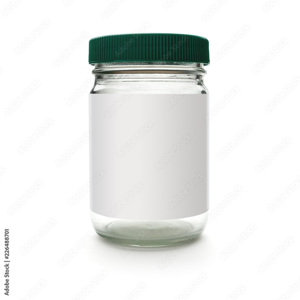 Glass jar on white background with shadow blank label green cap Glass jar on white background with shadow blank label green cap