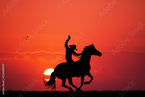 Rodeo cowboy at sunset