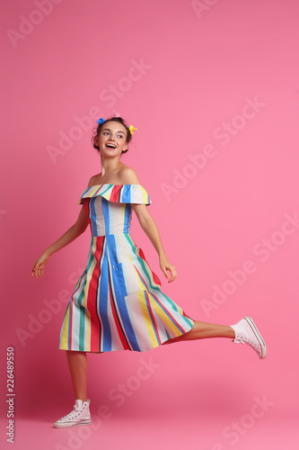 Fashion cool girl posing  on pink background. Young hipster woman, studio shot