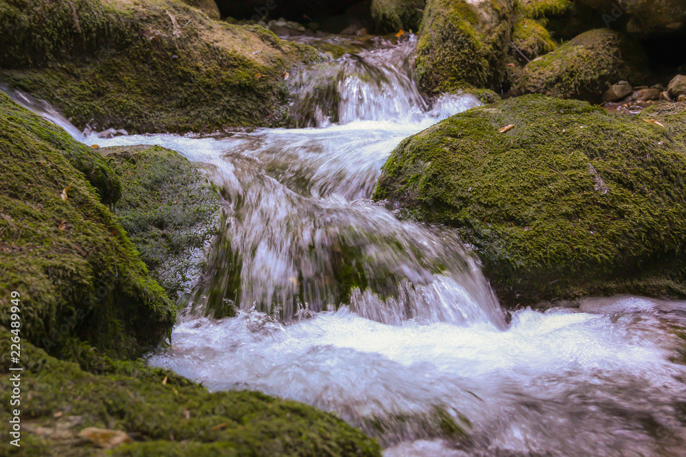 Waterfall with green stone