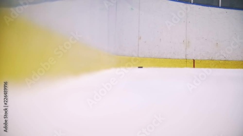 The puck bumps into into the enclosure wall and slowly rolls up to the camera photo