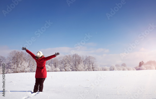 Happy woman in winter landscape on snowy landscape. Person outdoors on sunny day