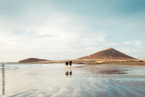 El Médano, Tenerife, Canary Islands, Spain - September 28, 2018: an older couple walking through El Médano beach, in south of Tenerife island