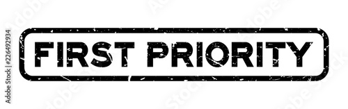 Grunge black first priority word square rubber seal stamp on white background