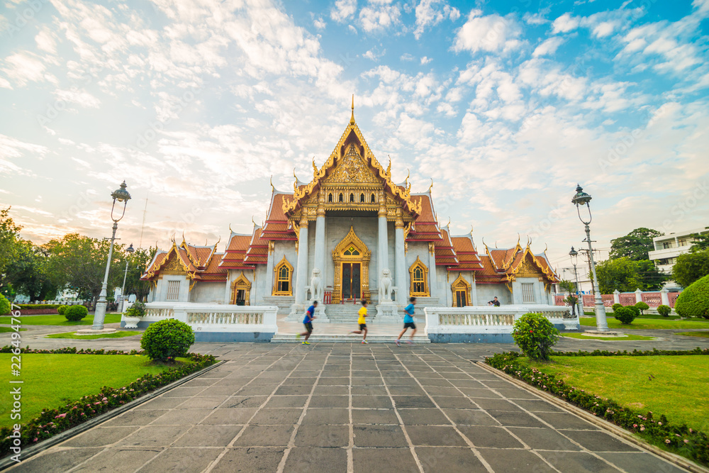 Naklejka premium Marble buddhist Bangkok Wat Benchamabophit temple evening sunset sky with cloud