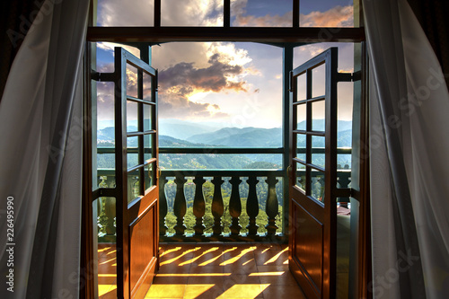 Beautiful Golden Hour and Himalayan ranges seen from hotel room through wooden glass door