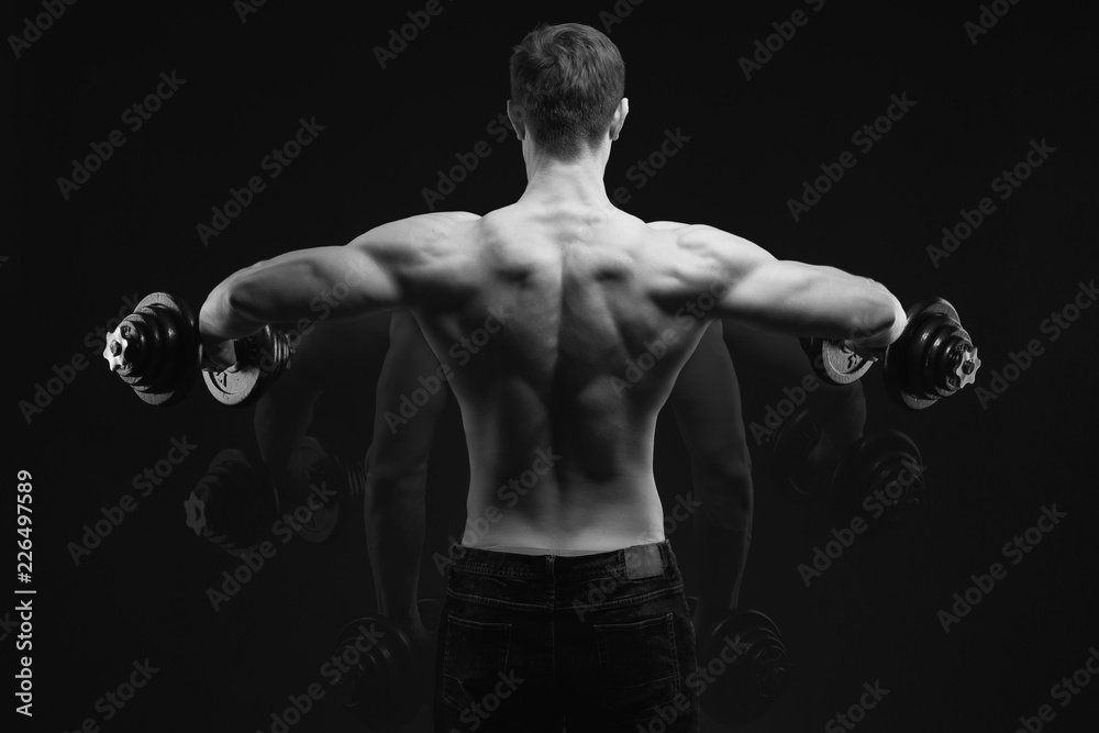 Black and white conept image Dumbbell Lateral Raise Bodybuilder turning  back raising hands pumping up shoulders muscle exercise Power Partials  routine with dumbbells on gym Dramatic studio shot Stock Photo | Adobe
