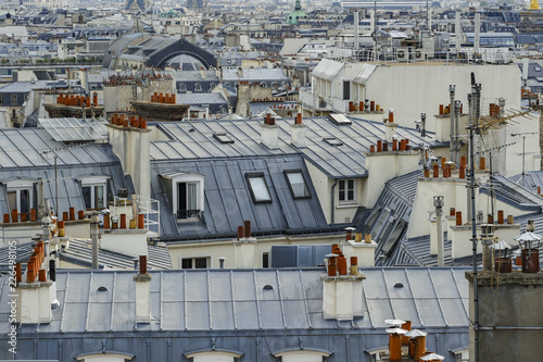 Photography The roofs of Paris and its chimneys under a clouds sky