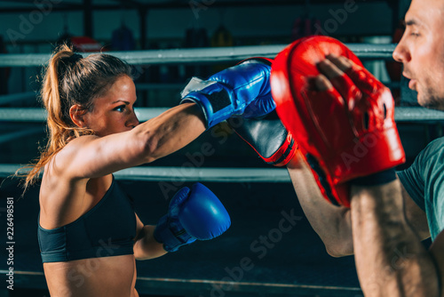 Woman on boxing training with trainer