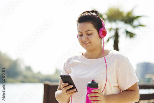 Woman choosing playlist for morning running photo