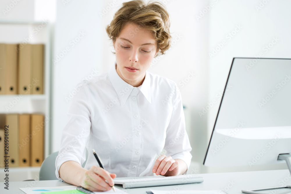 Young serious business woman with computer Young serious business woman with computer