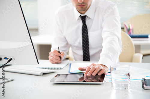 Young businessman working with tablet computer
